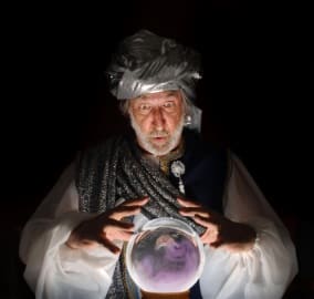 Swami gazing into a crystal ball