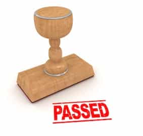 A stamp marked 'PASSED', symbolizing success in passing the pediatric board exam.