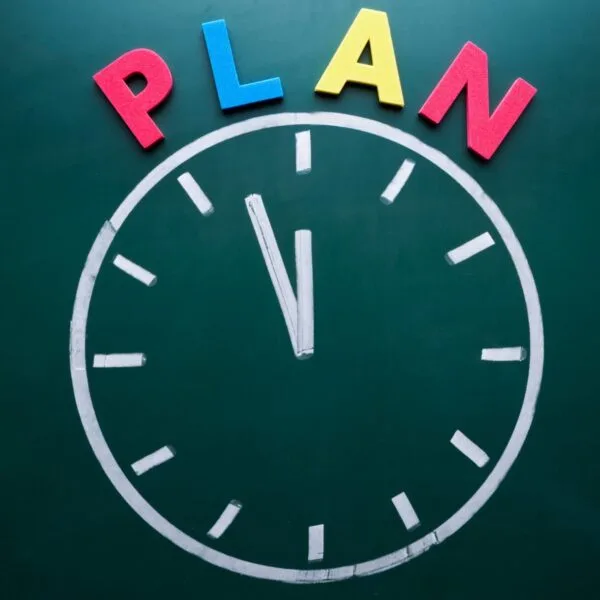 Clock illustration with the word ‘PLAN’ above it, representing the importance of structured time management when creating a pediatric board study plan.