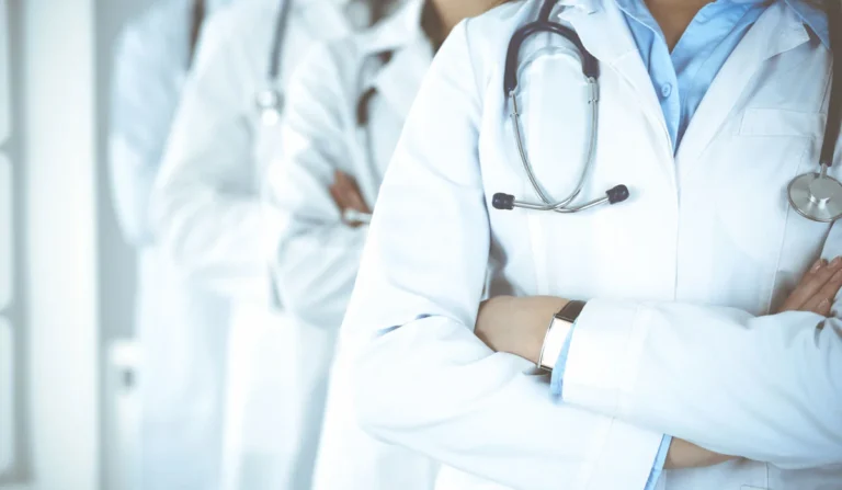 Pediatricians standing together in white coats, representing the community supported by Pediatrics Board Review.