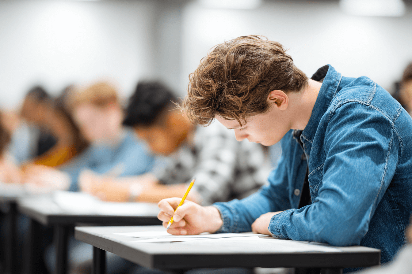 Medical student focusing during a written exam, developing test-taking skills for board certification