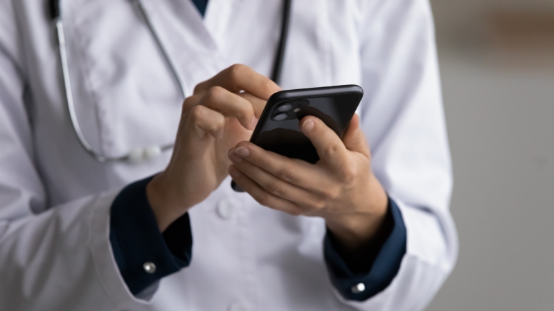 Pediatric resident studying on a cell phone